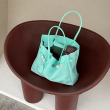 Aqua Sencieres large jelly Firkin bag, glossy translucent TPU handbag — close-up of the turn-lock detail