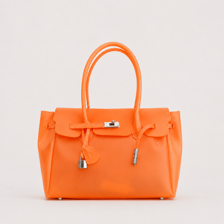 Orange Sencieres jelly Firkin bag, glossy translucent TPU handbag — front view