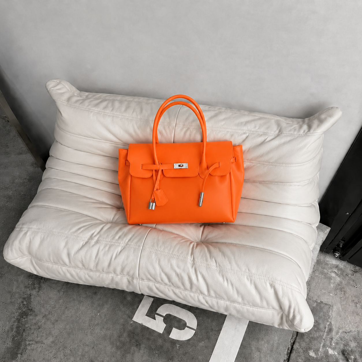 Orange Sencieres jelly Firkin bag, glossy translucent TPU handbag — angled side view