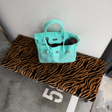 Aqua Sencieres large jelly Firkin bag, glossy translucent TPU handbag — held in hand