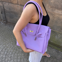 Purple Sencieres jelly Firkin bag, glossy translucent TPU handbag — angled side view