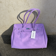 Purple Sencieres jelly Firkin bag, glossy translucent TPU handbag — held in hand