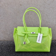 Apple Sencieres jelly Firkin bag, glossy translucent TPU handbag — close-up of the turn-lock detail