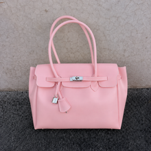 Pink Sencieres jelly Firkin bag, glossy translucent TPU handbag — angled side view